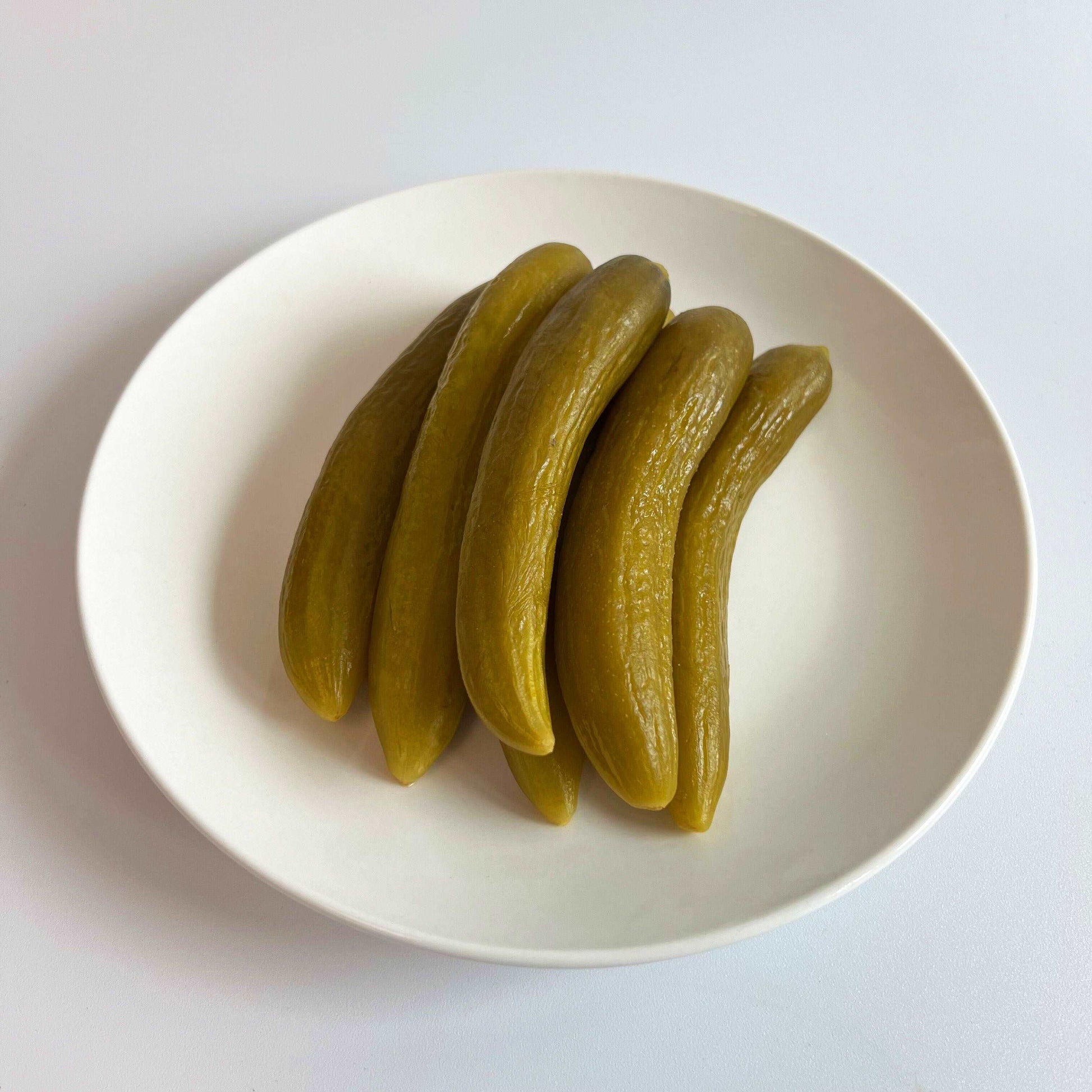 Damaski Cucumber Pickles On A White Plate Top View Damaski.com
