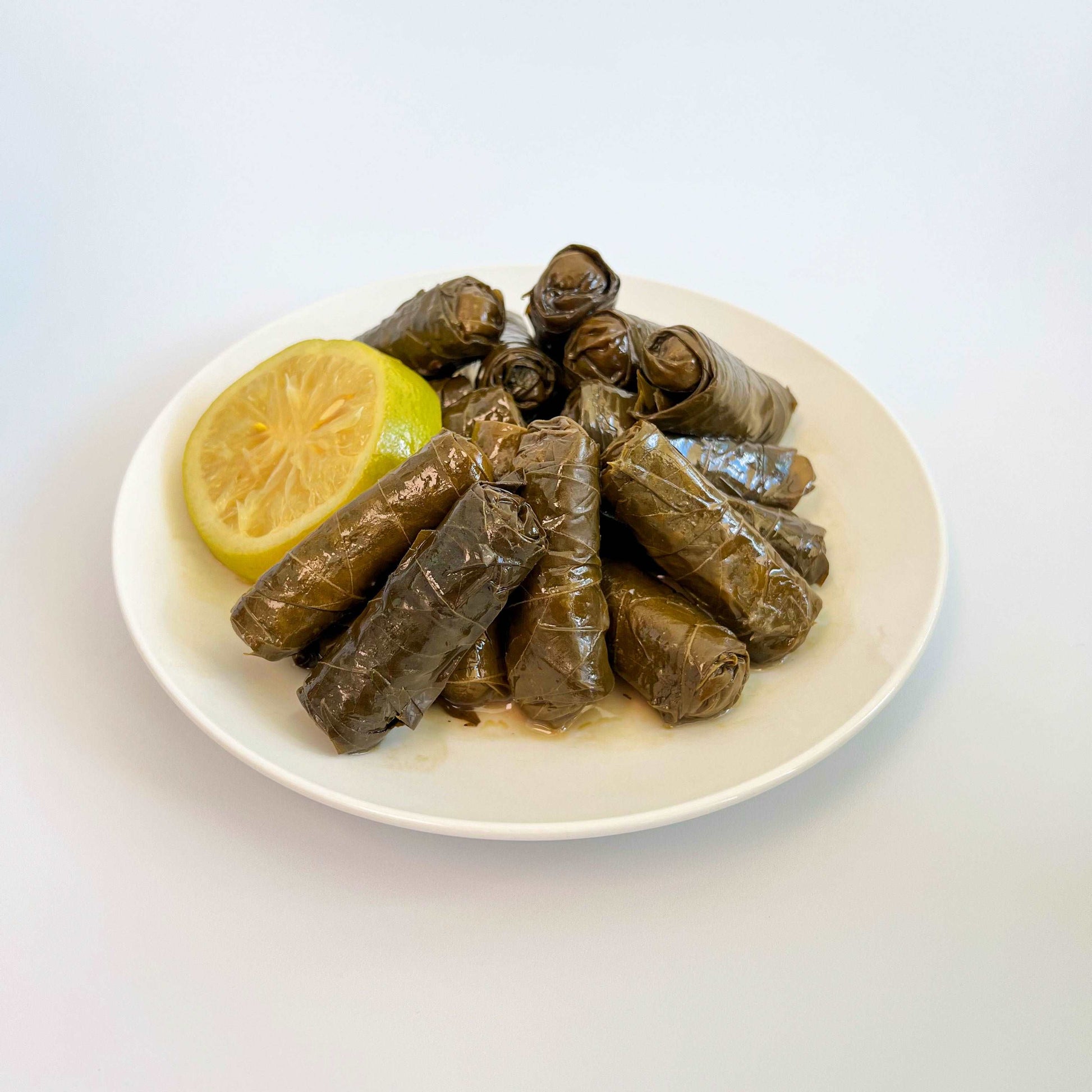 Damaski Stuffed Grape Leaves On A White Plate Damaski.com